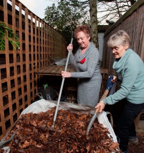 Kath and Ginette tend the compost heap
