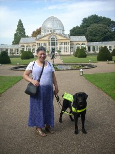 Noula, a local partially-sighted woman, with her guide dog enjoying a trip to Kew Gardens