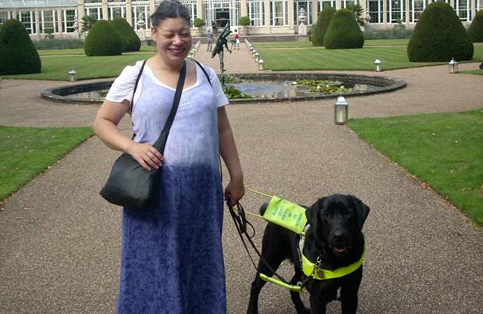 Partially sighted Noula with her guide dog on a trip to Kew Gardens
