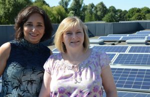 Councillor Binda Rai and school business manager Sharon Fida on the roof with the panels