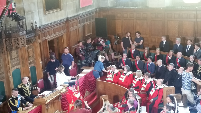 Elizabeth Hurley and extras in the council chamber filming The Royals