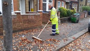 Street sweeper clearing away fallen leaves
