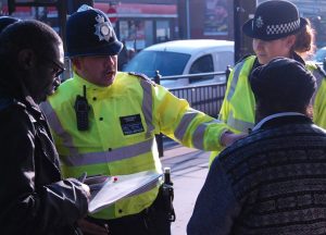 Police and council officers chatting to trader in Southall during the operation