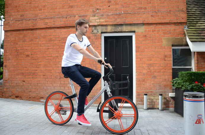 One of the 'dockless' Mobike hire-bicycles being ridden in Ealing