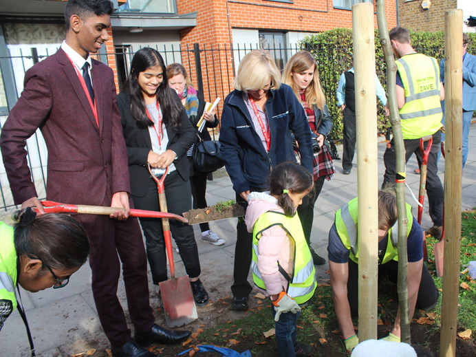 Students planting trees outside Featherstone High School