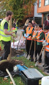 Trees for Cities staff member explaining some tree facts to pupils outside Featherstone High School