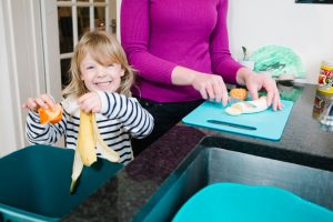 Mum and daughter recycling food waste in Ealing