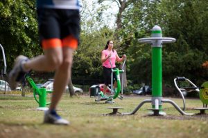 Using outdoor gym equipment in local park