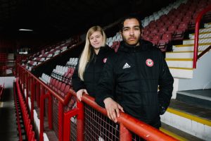 Kathryn of Brentford FC CST, and young carer Ali, at the club's stadium