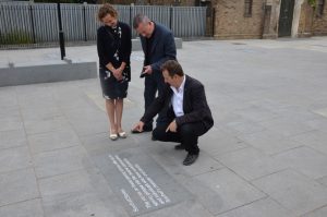 Council leader Julian Bell inspects one of the new historical slabs outside St John's Church in Southall