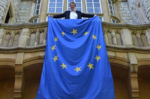 Council leader Julian Bell holding an EU flag at Ealing Town Hall