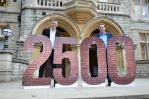 Councillors Peter Mason and Julian Bell with 2,500 number - the target for new affordable homes