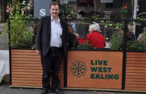 Councillor Julian Bell next to a 'parklet' in West Ealing