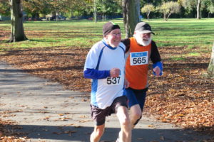 Two runners at the Ealing Mile in Lammas Park