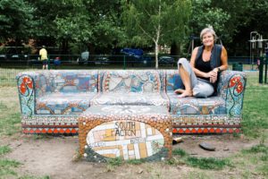 Rachel Pepper from Artification, sitting on the mural bench