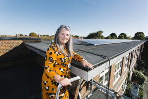 Amanda Hancock next to the solar panels at Lady Margaret Primary School