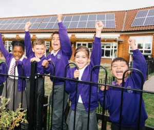 Wood End Primary School council members in front of new solar panels