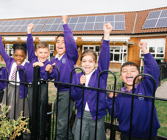 Wood End Primary School council members in front of new solar panels