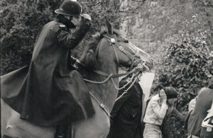 Mounted police officer threatens protestors