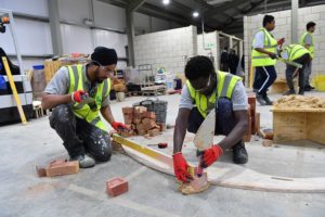 Students on construction academy course learning bricklaying skills