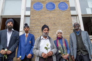 Plaques on Southall Town Hall commemorate Gurdip Singh Chaggar, Blair Peach and Misty in Roots. From right to left: Clarence Baker (original manager of Misty in Roots, and badly injured on 23 April 1979); Celia Stubbs, partner of Blair Peach, who was killed); Karamjit Singh Chaggar, brother of Gurdip Singh Chaggar (who was killed in 1976), Sevak Singh Chaggar, Karamjit's grandson, and Jatinder Singh Chaggar, Karamjit's son. Photo by John Sturrock