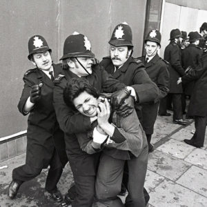 Police grab a local man during Southall riot 23 April 1979. Photo by John Sturrock