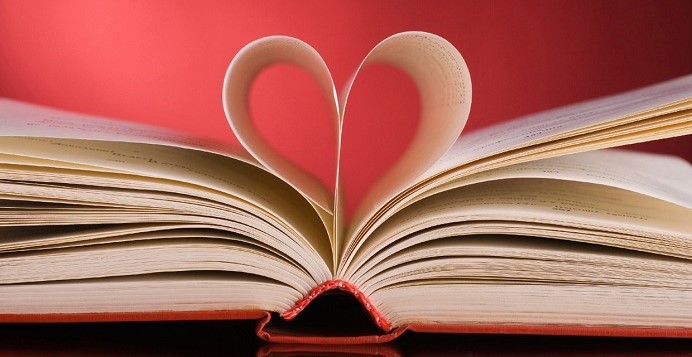 Open book with middle pages folded back in to a heart