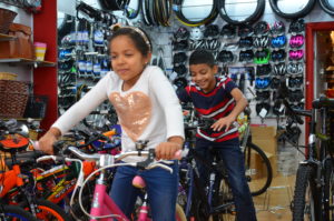 All smiles for Maryan and her brother Yahya riding their new bikes