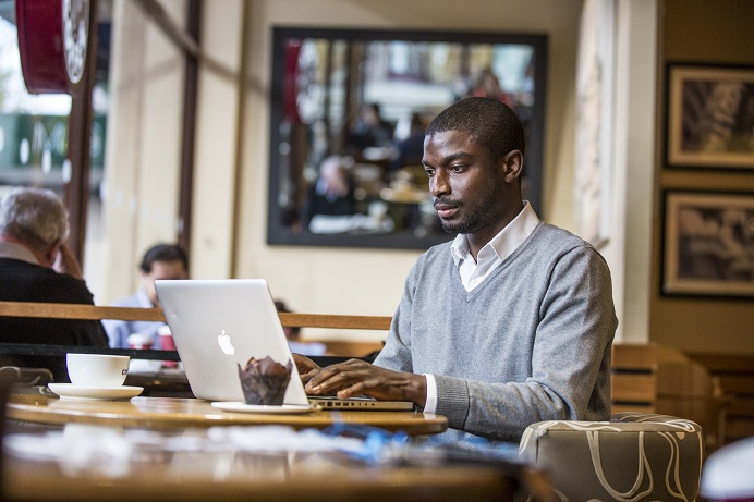 New online account. Man working on laptop