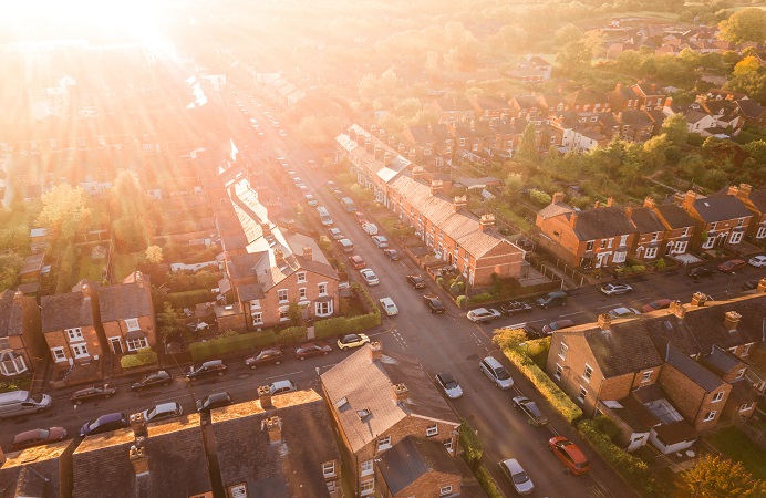 Sun rising over homes