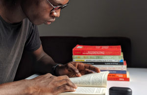 Man reading a book in a library