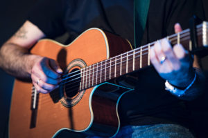 Guitarist with guitar - photo by Adi Goldstein (Unsplash)