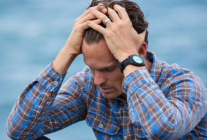 Man sitting looking stressed, worried