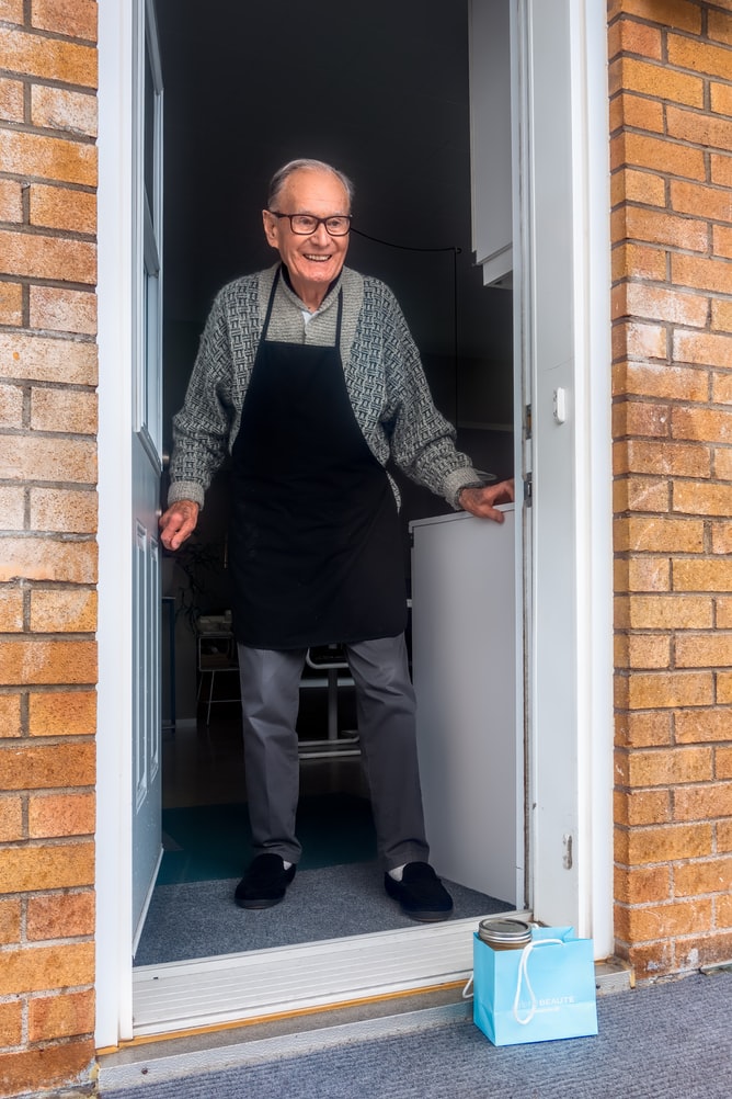 Elderly man opens door