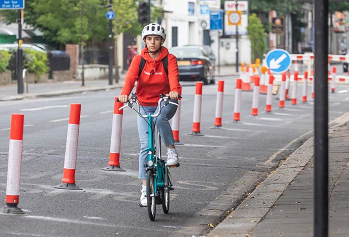 Cyclist using new cycle lane in The Vale, Acton