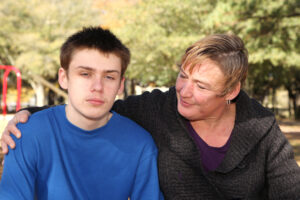 Mother comforts teenager