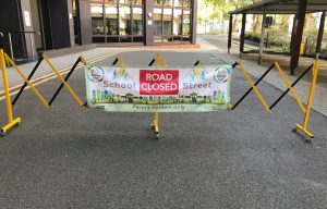 road barrier with banner school streets