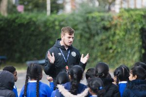 Coach Tommy teaching pupils at St Anselm's Primary School