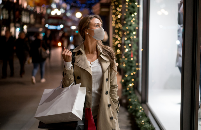 Lady with face covering looking in shop window