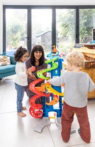 Simmi Bajaj, co-founder of Ealing Toy Library, playing with one of the toys with one of her daughters and friends