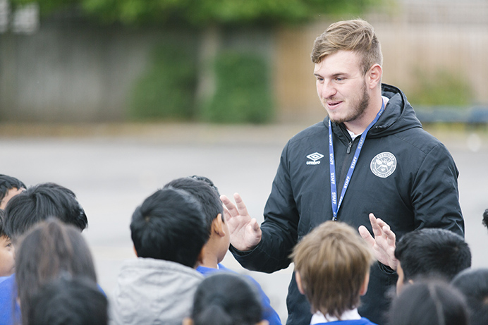 Coach Tommy teaching pupils at St Anselm's Primary School