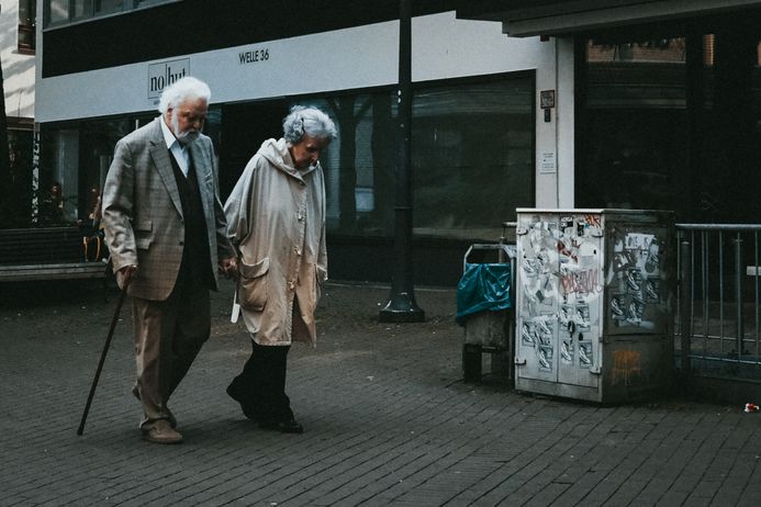 older couple walking on street