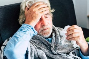 Flu - older man suffering at home with symptoms