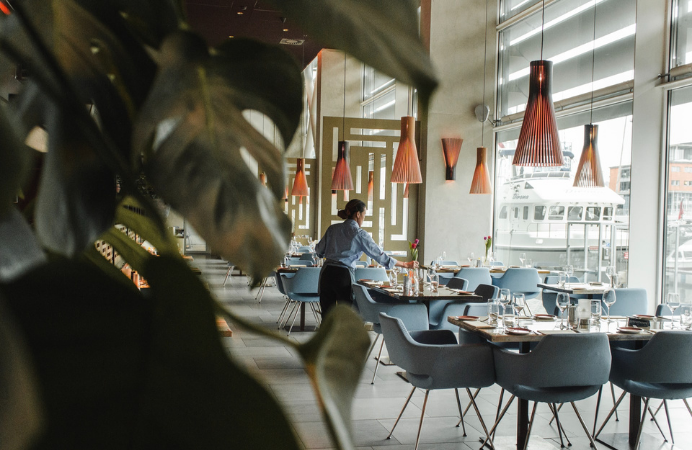 A waiter preparing restaurant tables