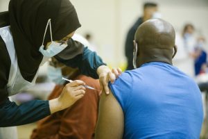 Man receiving his COVID-19 vaccination