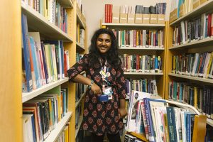 Project Choice student Kajani Ambikaiplan in the library, stacking shelves