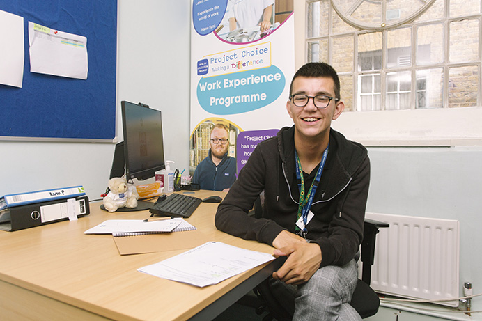 Project Choice student Aaron Parker in the office sitting at a desk