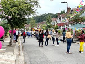 People standing in the street talking, during a street party