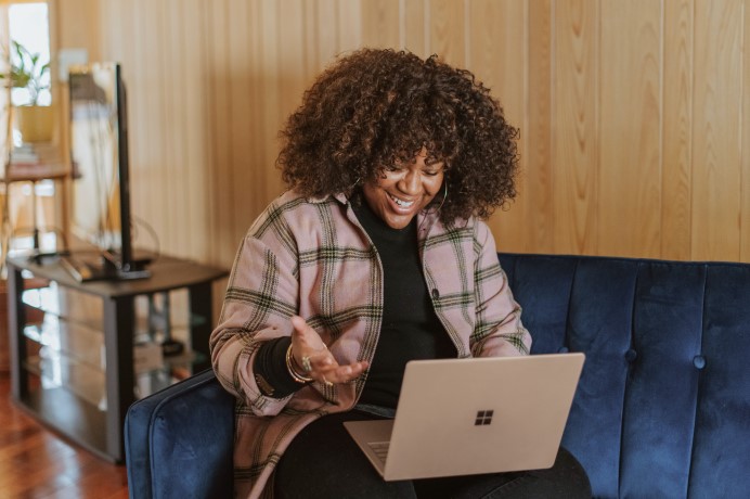 Lady looking happy using a laptop