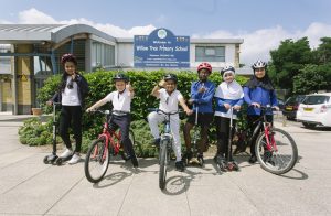 Pupils at Willow Tree Primary School on bikes and scooters